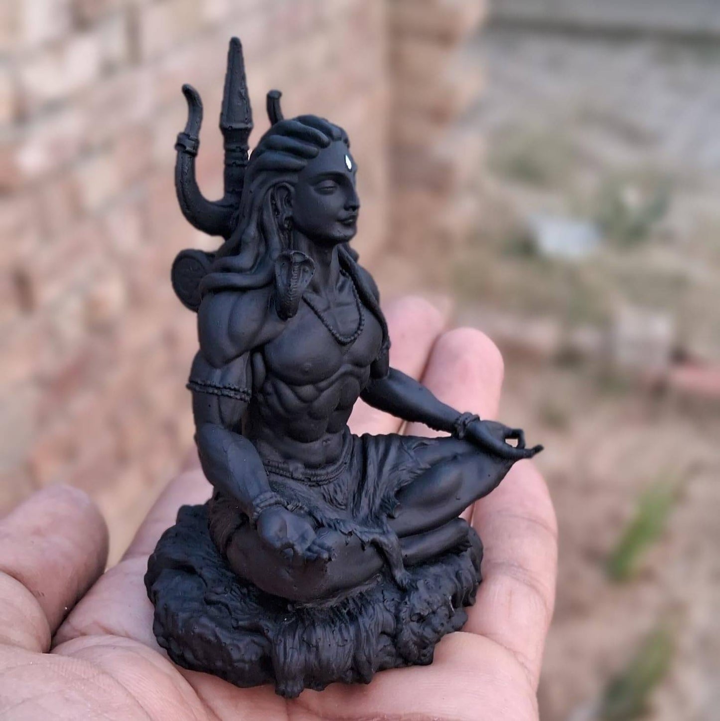 Side view of Adiyogi Meditation Statue held in hand, featuring Lord Shiva in dhyana mudra, ideal for spiritual home decor.