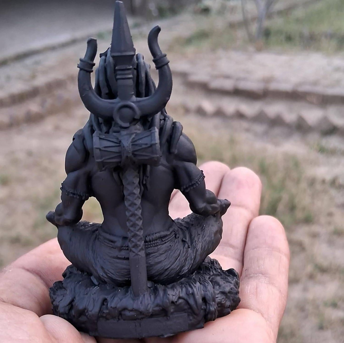 Rear view of Adiyogi Meditation Statue showing detailed trishul and hair design, crafted from durable UV resin for decor use.