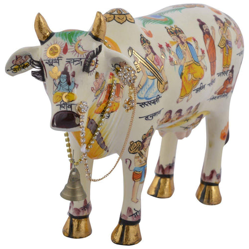 Front angle of Kamdhenu Cow With Calf Hand Painted Polyresin Statue Of Hindu God (20 CM Size) with intricate deity illustrations and ornamental jewelry.
